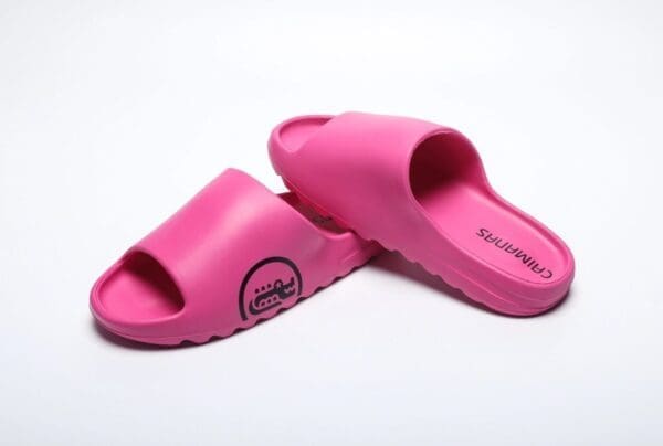 A pair of pink sandals on top of a white surface.