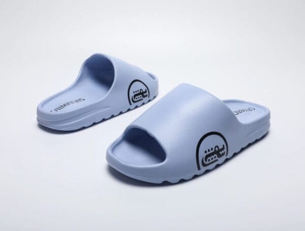 A pair of blue sandals on top of a white surface.