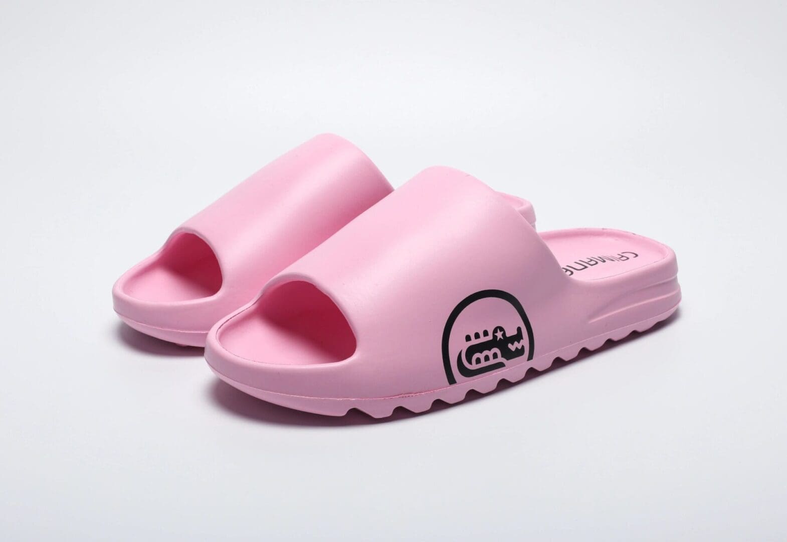 A pair of pink sandals on top of a white surface.