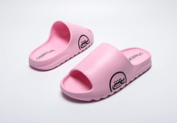 A pair of pink sandals on top of a white surface.