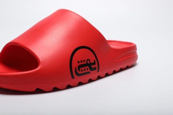 A close up of the bottom part of a red sandal.