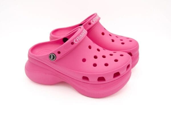 A pair of pink crocs are on display.