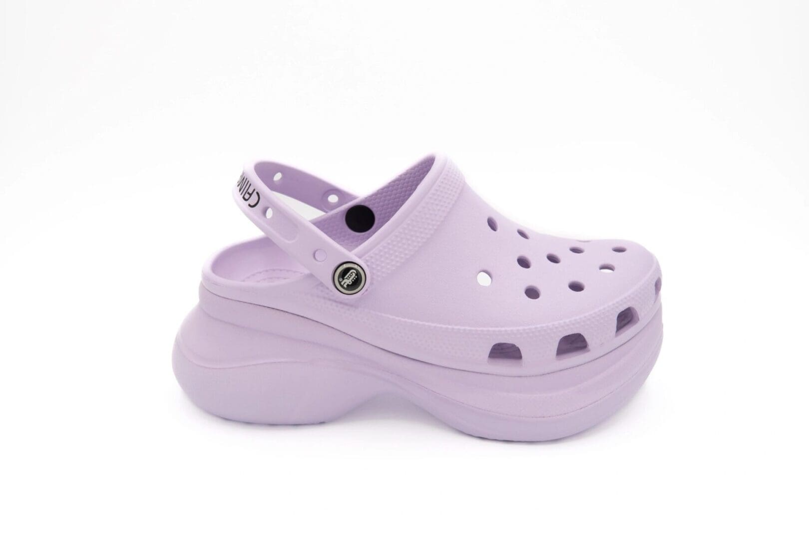 A pair of purple shoes with holes on them.