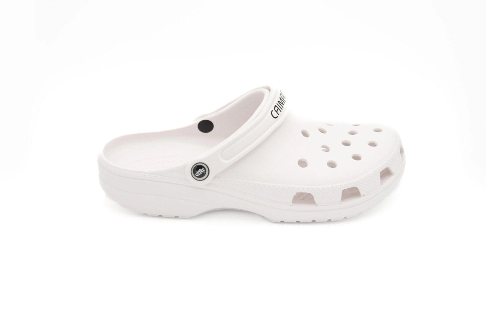 A white shoe with holes on the side of it.