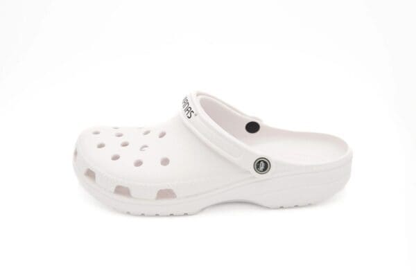 A white crocs shoe with the word " crocs " on it.