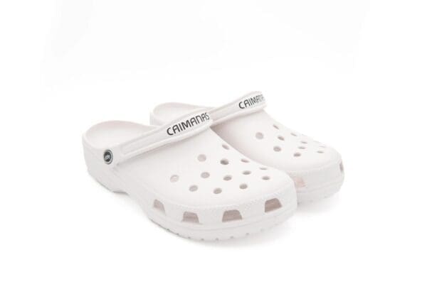 A pair of white crocs with the word " crocs " written on them.