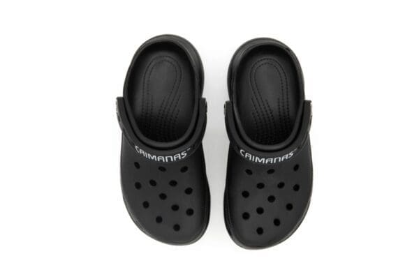 A pair of black crocs with the word " crocband " written on them.