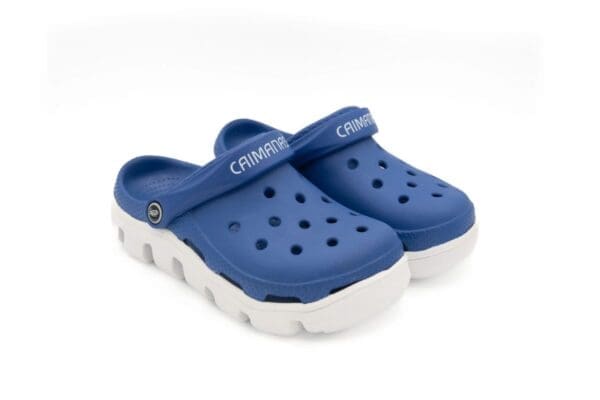 A pair of blue and white crocs with the word crock on them.