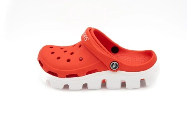 A pair of red and white crocs on top of a white background.