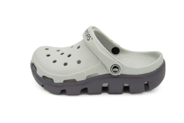 A pair of white and grey crocs with black soles.