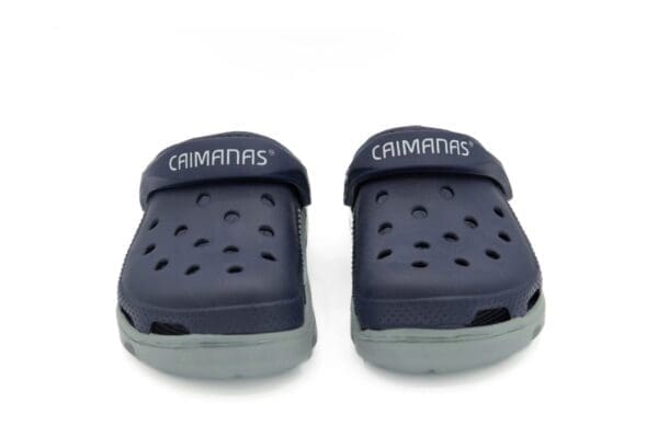 A pair of crocs shoes with the word crimmins on them.