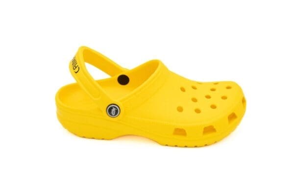 A yellow crocs shoe with the word crocs on it.