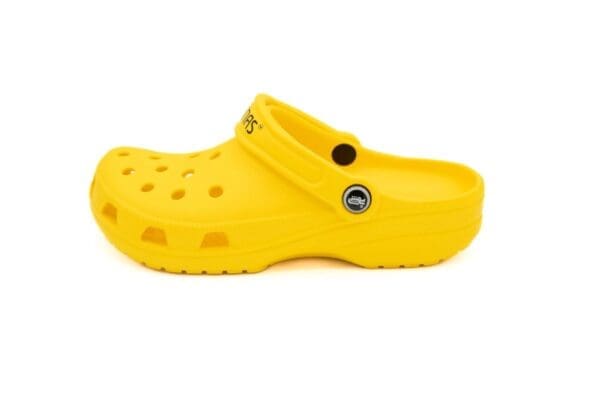 A yellow crocs shoe with black and white lettering.