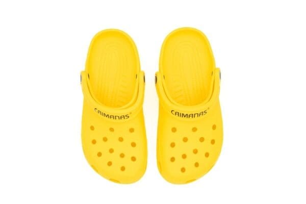 A pair of yellow crocs with the word crocband written on them.