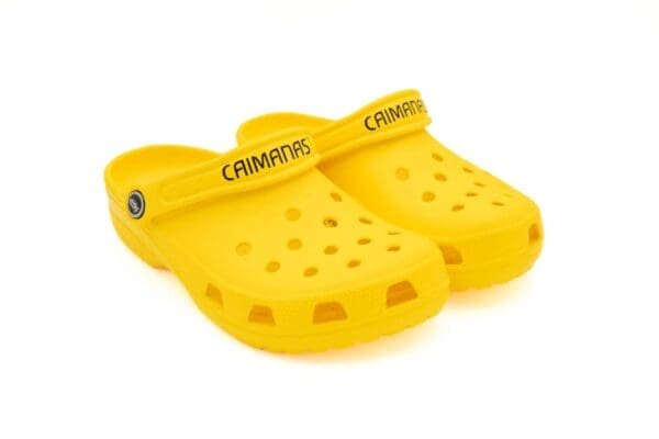 A pair of yellow crocs with the word " campuro " written on them.