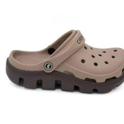 A pair of brown crocs with a black sole.