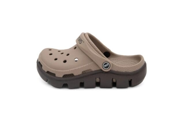 A pair of brown crocs with black soles.