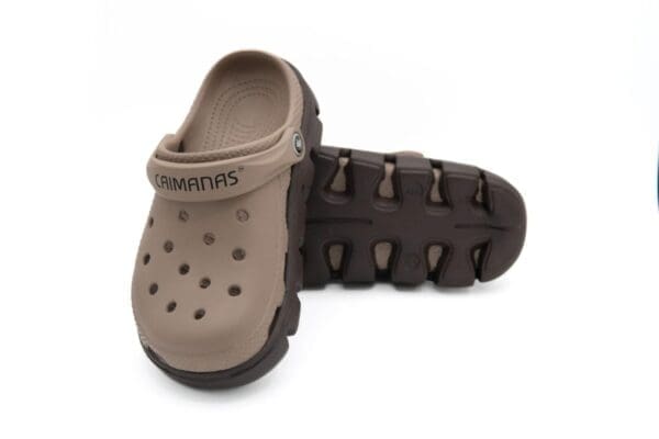 A pair of brown and black crocs shoes.