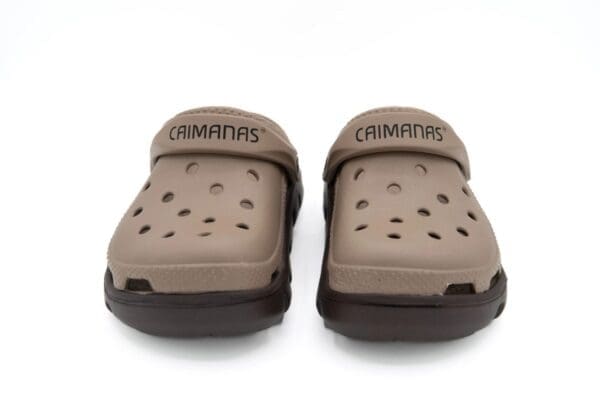 A pair of crocs sandals on top of a white surface.