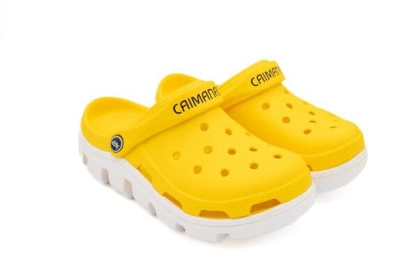 A pair of yellow crocs with white soles.