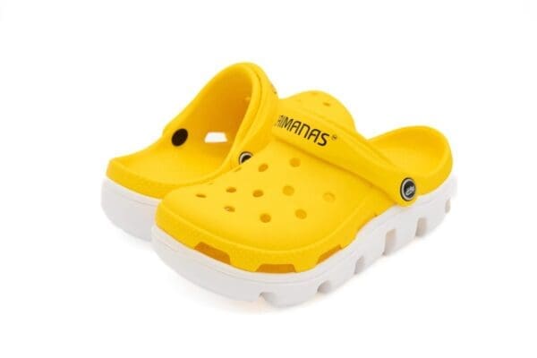 A pair of yellow and white crocs with the word " mariners ".