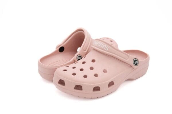 A pair of pink shoes with holes on them.