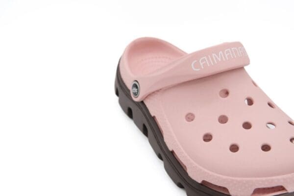 A close up of the bottom of a pink and brown crocs