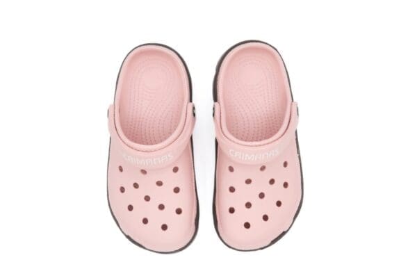 A pair of pink shoes with black dots on them.